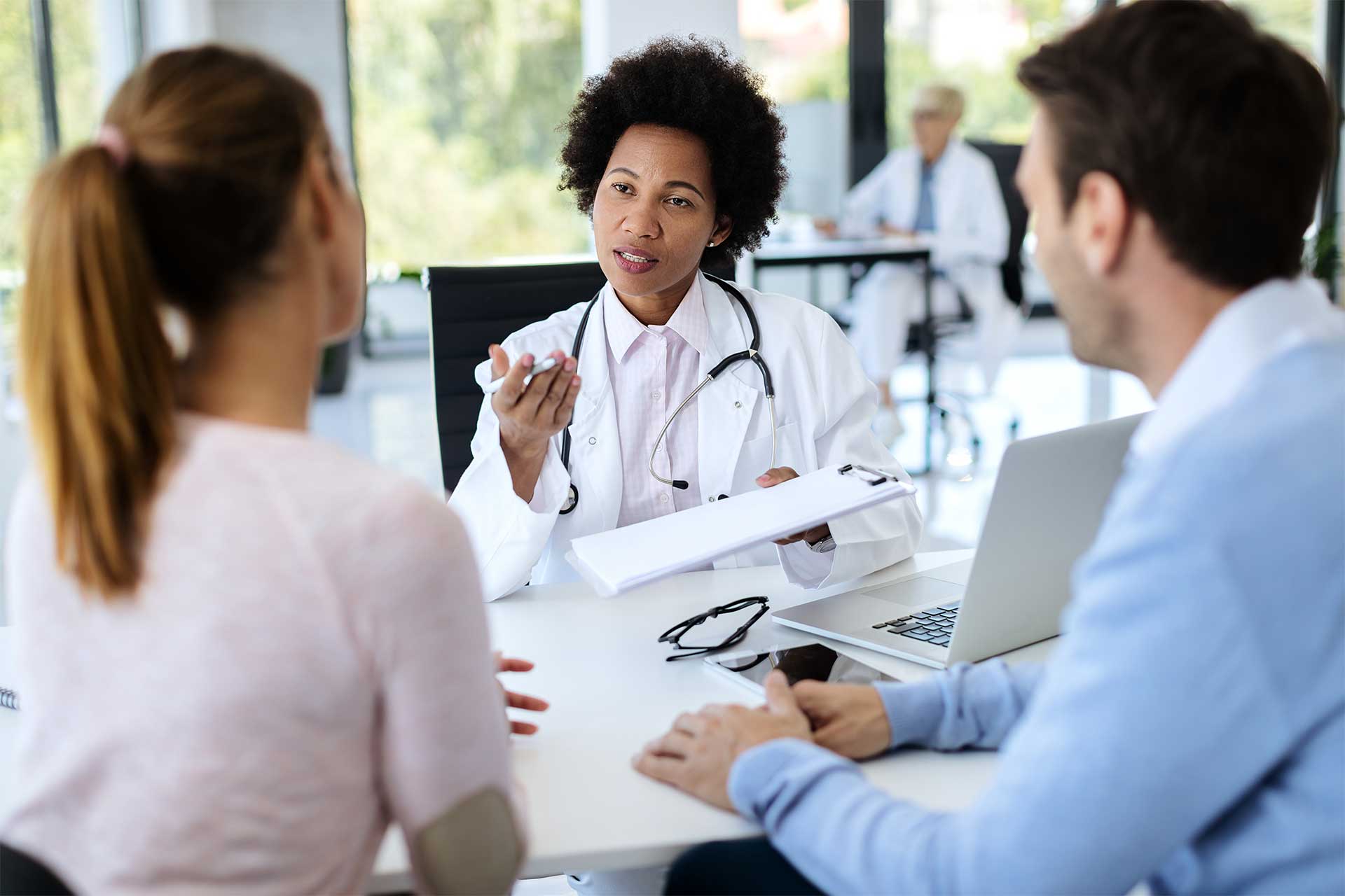 black-female-doctor-talking-to-a-couple-about-thei-2023-11-27-04-53-08-utc.jpg